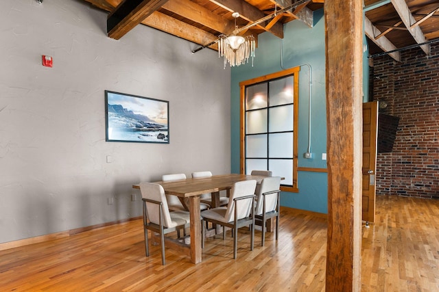 509 W Olive St Unit 206, Springfield, MO 65806 - dining room featuring hardwood / wood-style floors, beam ceiling, and a chandelier