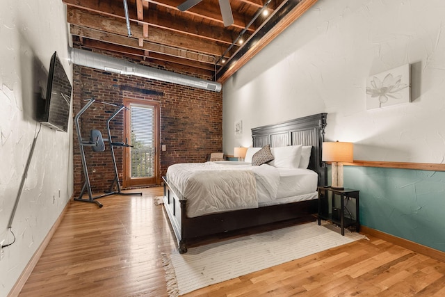 509 W Olive St Unit 206, Springfield, MO 65806 - bedroom with wood finished floors and brick wall