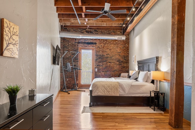 509 W Olive St Unit 206, Springfield, MO 65806 - bedroom featuring light wood-style flooring, brick wall, and a towering ceiling