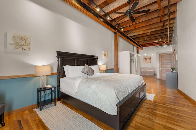 509 W Olive St Unit 206, Springfield, MO 65806 - bedroom featuring wood finished floors, beamed ceiling, ensuite bathroom, and a towering ceiling