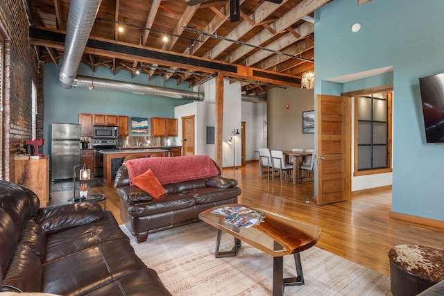 509 W Olive St Unit 206, Springfield, MO 65806 - living area with a towering ceiling, light wood-style floors, and beamed ceiling
