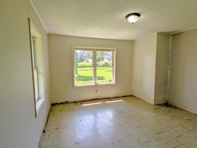13802 E State Highway 76, Taneyville, MO 65759 - empty room with healthy amount of natural light, tile patterned floors, and a textured ceiling