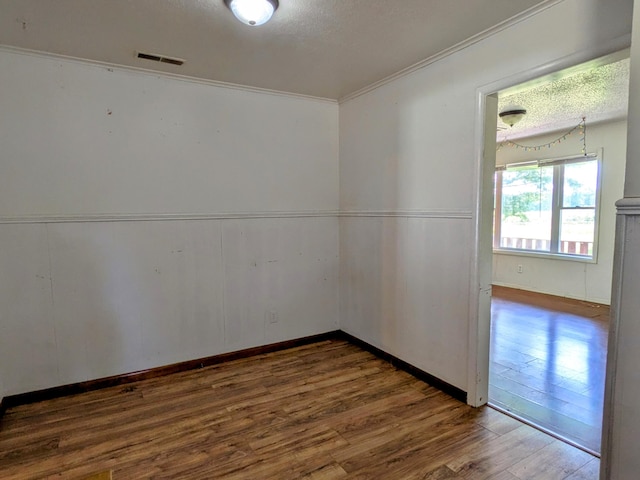 13802 E State Highway 76, Taneyville, MO 65759 - unfurnished room featuring wood finished floors, ornamental molding, and a textured ceiling