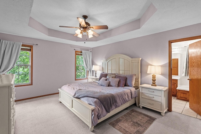 2602 S 15th Ave, Ozark, MO 65721 - bedroom with light carpet, multiple windows, a textured ceiling, a tray ceiling, and a ceiling fan
