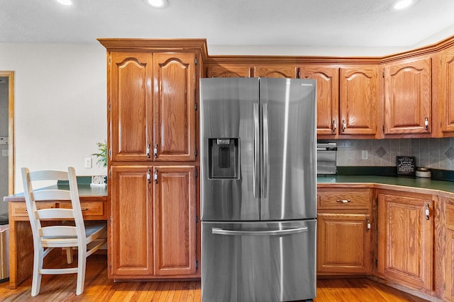2602 S 15th Ave, Ozark, MO 65721 - kitchen featuring stainless steel fridge, brown cabinetry, light wood finished floors, tasteful backsplash, and recessed lighting