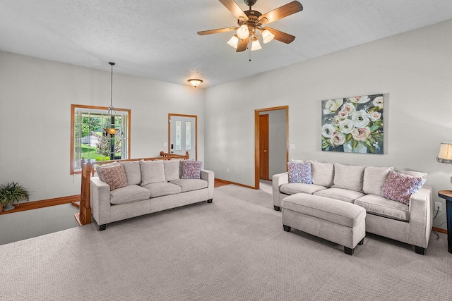 2602 S 15th Ave, Ozark, MO 65721 - living room with light carpet, a ceiling fan, a chandelier, and a textured ceiling