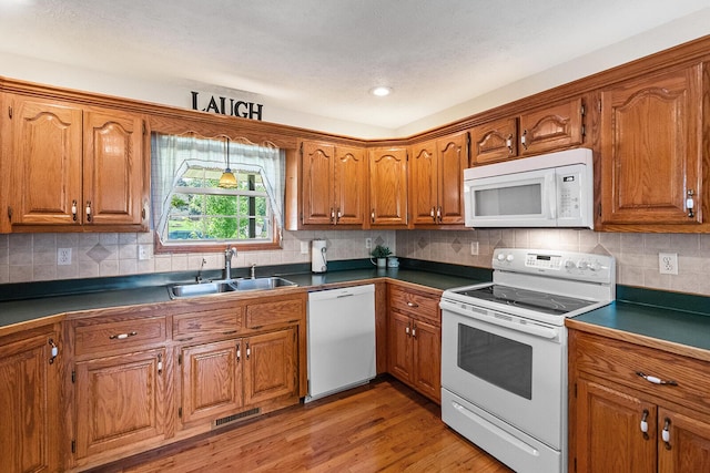 2602 S 15th Ave, Ozark, MO 65721 - kitchen featuring white appliances, brown cabinets, and dark countertops