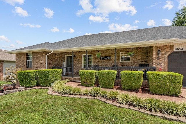 2602 S 15th Ave, Ozark, MO 65721 - ranch-style home featuring a porch, brick siding, a shingled roof, and a front yard