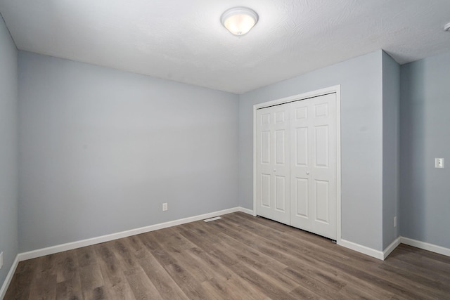 1020 Gretchen St, Nixa, MO 65714 - unfurnished bedroom with wood finished floors and a closet