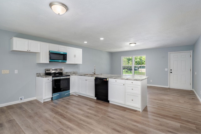 1020 Gretchen St, Nixa, MO 65714 - kitchen featuring appliances with stainless steel finishes, a peninsula, white cabinetry, light wood finished floors, and light stone countertops