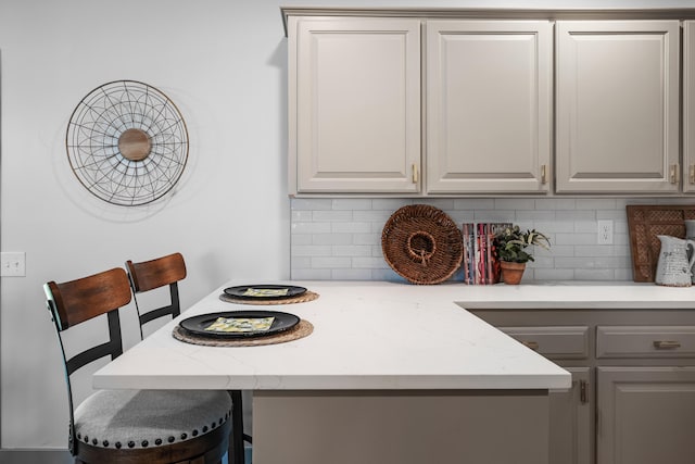 620 E Summit St, Bolivar, MO 65613 - kitchen with decorative backsplash and gray cabinetry