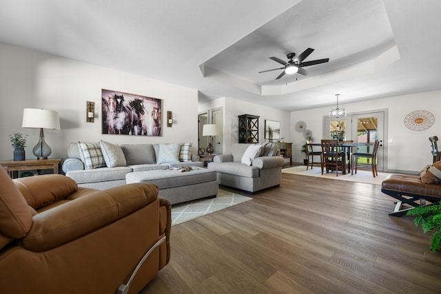 620 E Summit St, Bolivar, MO 65613 - living area with a tray ceiling, wood finished floors, ceiling fan, and a chandelier