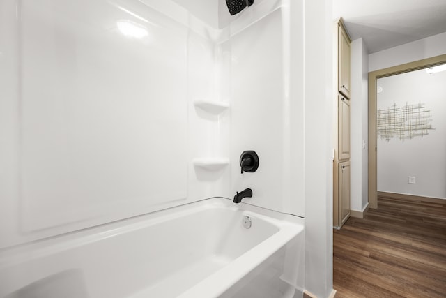 620 E Summit St, Bolivar, MO 65613 - bathroom with washtub / shower combination and wood finished floors