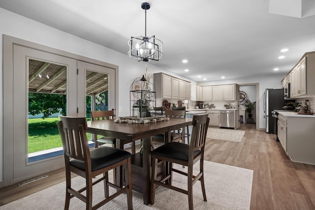 620 E Summit St, Bolivar, MO 65613 - dining space with healthy amount of natural light, a chandelier, light wood-style flooring, and recessed lighting