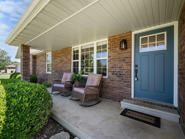 620 E Summit St, Bolivar, MO 65613 - doorway to property with covered porch and brick siding