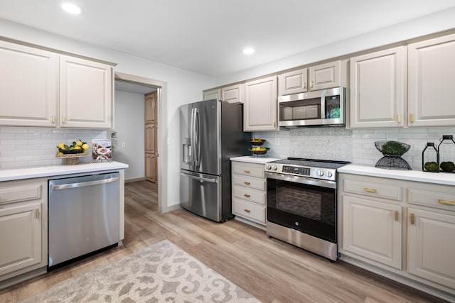 620 E Summit St, Bolivar, MO 65613 - kitchen with stainless steel appliances, light countertops, tasteful backsplash, light wood-style floors, and recessed lighting