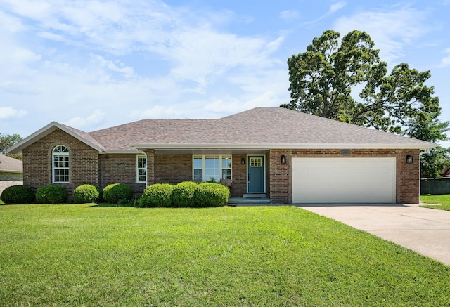 620 E Summit St, Bolivar, MO 65613 - ranch-style house with concrete driveway, a front lawn, an attached garage, and brick siding
