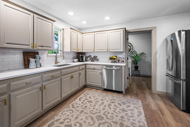 620 E Summit St, Bolivar, MO 65613 - kitchen with appliances with stainless steel finishes, gray cabinets, decorative backsplash, light wood-type flooring, and light countertops