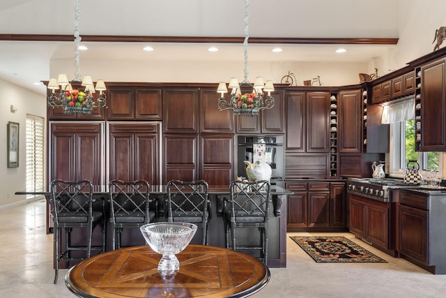 10 Patterson Ave, Branson, MO 65616 - kitchen with a chandelier, stainless steel gas cooktop, dark brown cabinetry, and recessed lighting