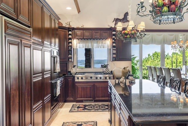 10 Patterson Ave, Branson, MO 65616 - kitchen with a chandelier, stainless steel gas cooktop, light tile patterned floors, paneled built in refrigerator, and open shelves