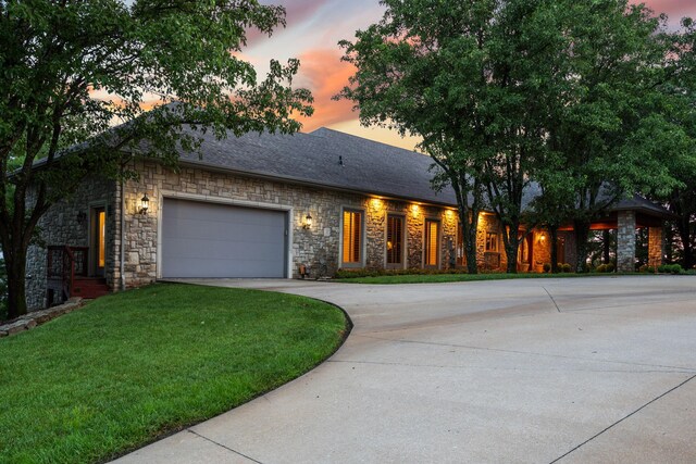 10 Patterson Ave, Branson, MO 65616 - ranch-style home featuring stone siding, concrete driveway, a garage, and a lawn