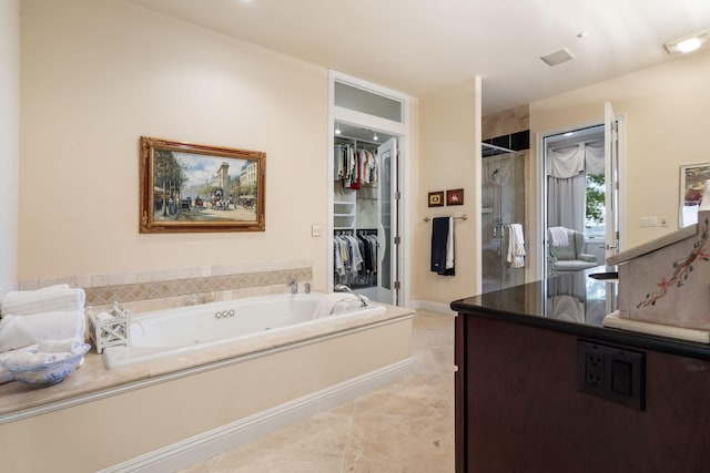 10 Patterson Ave, Branson, MO 65616 - bathroom featuring a shower stall, a whirlpool tub, vanity, tile patterned flooring, and a walk in closet
