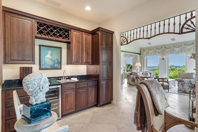 10 Patterson Ave, Branson, MO 65616 - kitchen with wine cooler, open floor plan, recessed lighting, light tile patterned floors, and dark stone countertops