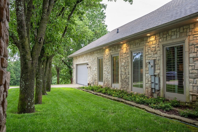 10 Patterson Ave, Branson, MO 65616 - view of green lawn featuring a garage and driveway