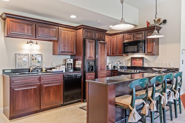 10 Patterson Ave, Branson, MO 65616 - kitchen with black appliances, dark countertops, hanging light fixtures, a peninsula, and a breakfast bar
