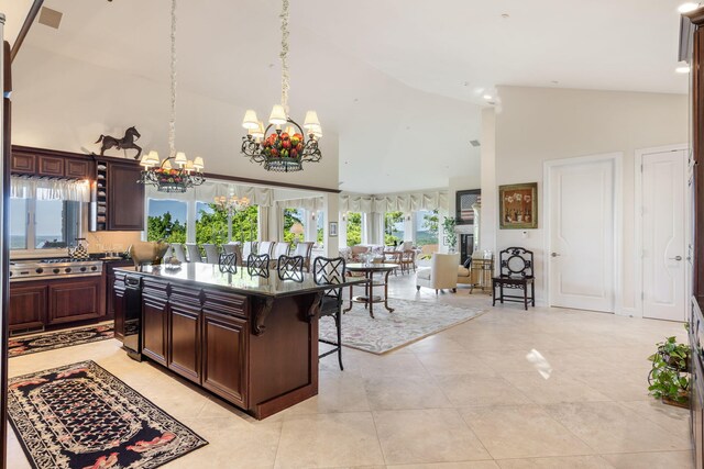 10 Patterson Ave, Branson, MO 65616 - kitchen featuring a chandelier, high vaulted ceiling, a breakfast bar, dark brown cabinets, and decorative light fixtures
