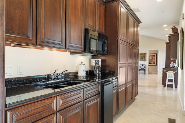10 Patterson Ave, Branson, MO 65616 - kitchen featuring black microwave, light tile patterned flooring, recessed lighting, vaulted ceiling, and dark stone counters
