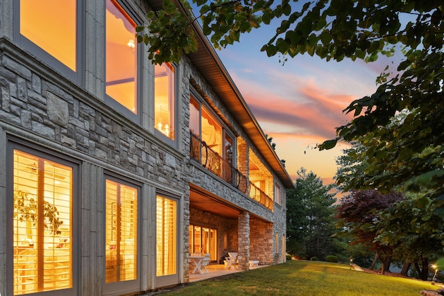 10 Patterson Ave, Branson, MO 65616 - view of home's exterior with stone siding, a lawn, and a patio