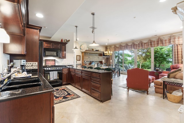 10 Patterson Ave, Branson, MO 65616 - kitchen featuring black appliances, a peninsula, open floor plan, pendant lighting, and recessed lighting
