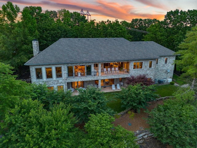 10 Patterson Ave, Branson, MO 65616 - back of property featuring stone siding, a chimney, a patio, and view of wooded area