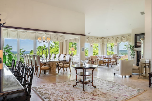 10 Patterson Ave, Branson, MO 65616 - dining area with a high ceiling, a chandelier, and light tile patterned flooring