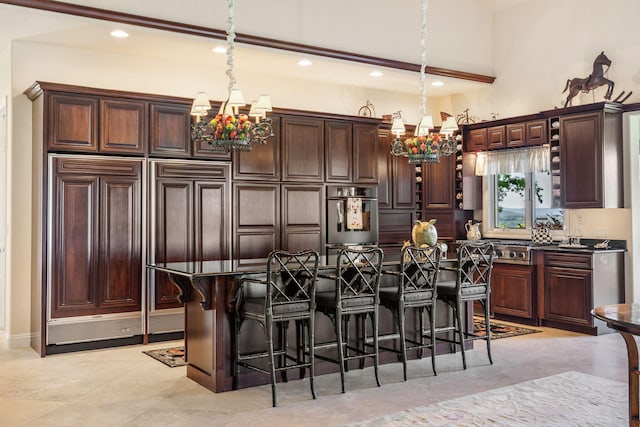 10 Patterson Ave, Branson, MO 65616 - kitchen featuring a chandelier, paneled refrigerator, a kitchen bar, and recessed lighting