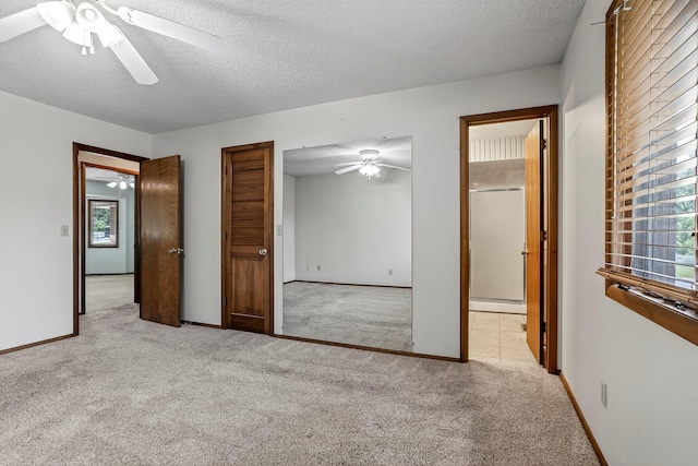 2812 E Linwood St, Springfield, MO 65804 - unfurnished bedroom with carpet flooring, multiple windows, ceiling fan, and a textured ceiling