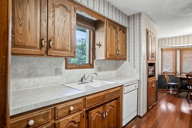 2812 E Linwood St, Springfield, MO 65804 - kitchen featuring dishwasher, wallpapered walls, brown cabinetry, light countertops, and a textured ceiling