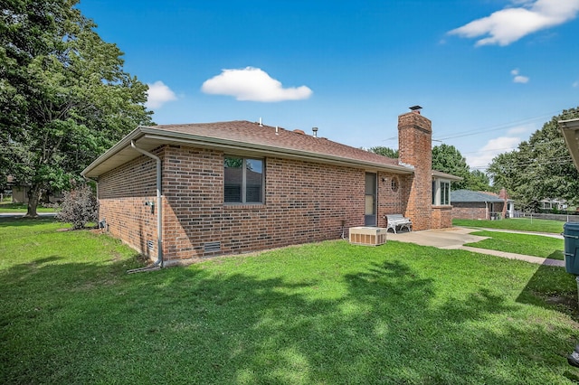 2812 E Linwood St, Springfield, MO 65804 - back of house with brick siding, a chimney, a patio, a yard, and a shingled roof