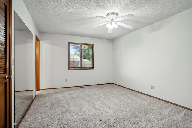 2812 E Linwood St, Springfield, MO 65804 - unfurnished bedroom with carpet flooring, a textured ceiling, and a ceiling fan
