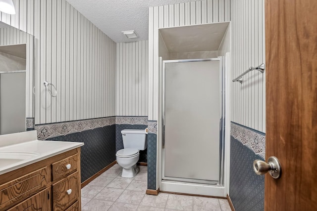 2812 E Linwood St, Springfield, MO 65804 - bathroom with wallpapered walls, vanity, a stall shower, a textured ceiling, and tile patterned flooring