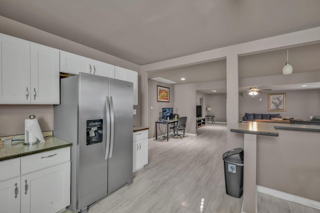 3197 S Grand Ave, Carthage, MO 64836 - kitchen with stainless steel fridge, open floor plan, white cabinets, dark countertops, and recessed lighting