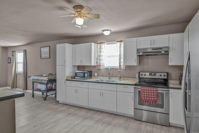 3197 S Grand Ave, Carthage, MO 64836 - kitchen with appliances with stainless steel finishes, under cabinet range hood, white cabinetry, and a ceiling fan