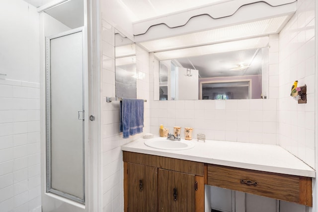 6665 State Highway 173, Cape Fair, MO 65624 - bathroom with tile walls, vanity, a stall shower, and decorative backsplash