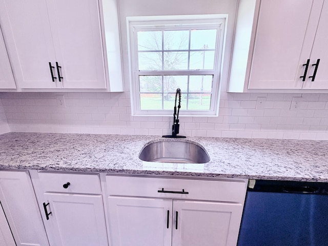 401 E 17th St, Lockwood, MO 65682 - kitchen with white cabinets, dishwashing machine, tasteful backsplash, and light stone counters
