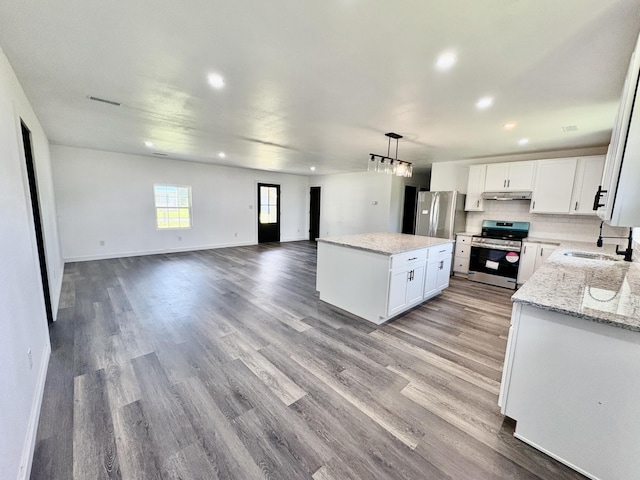 401 E 17th St, Lockwood, MO 65682 - kitchen featuring stainless steel appliances, recessed lighting, a center island, white cabinetry, and open floor plan