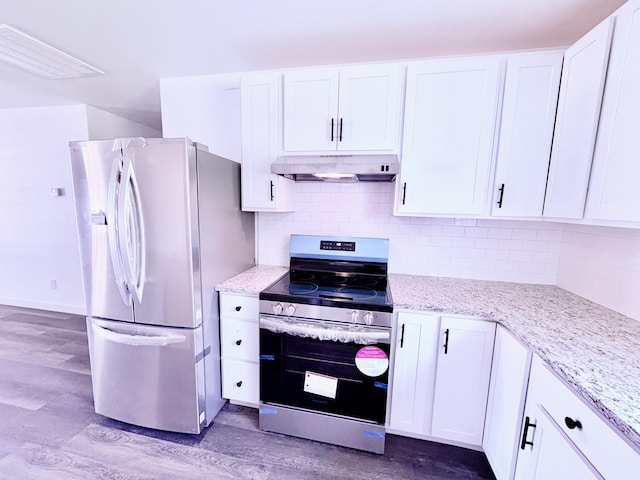 401 E 17th St, Lockwood, MO 65682 - kitchen with appliances with stainless steel finishes, under cabinet range hood, wood finished floors, and white cabinets