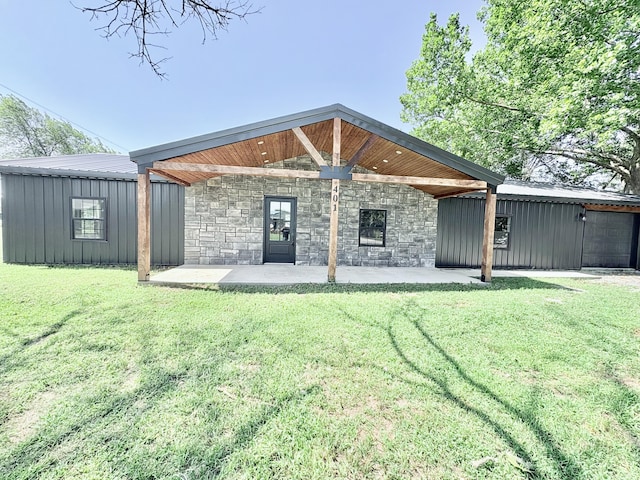 401 E 17th St, Lockwood, MO 65682 - rear view of house with a patio, a lawn, and stone siding