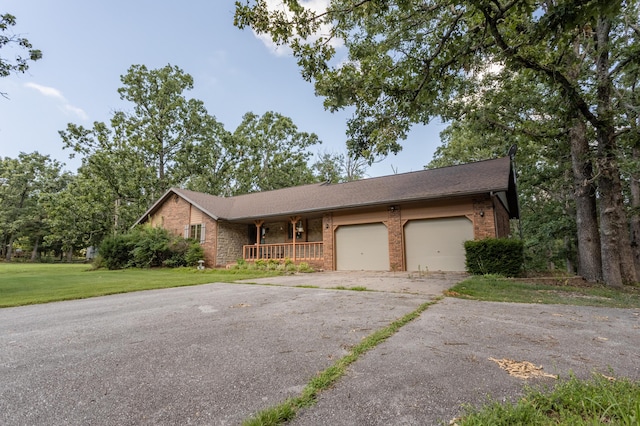 6337 S Farm Road 31, Billings, MO 65610 - ranch-style house featuring covered porch, brick siding, a front lawn, asphalt driveway, and a garage