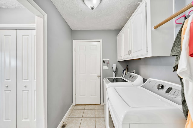 3477 W Broadmoor Ct, Springfield, MO 65807 - laundry area with independent washer and dryer, cabinet space, a textured ceiling, and light tile patterned floors